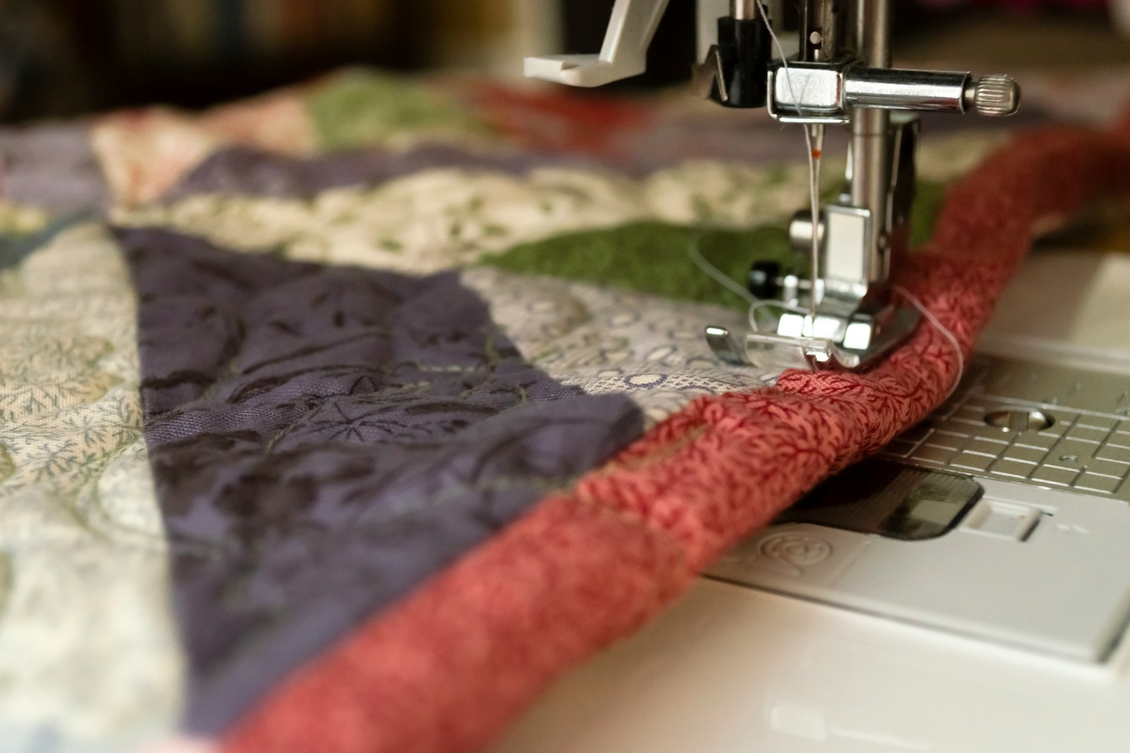 multicolored quilt being sewn